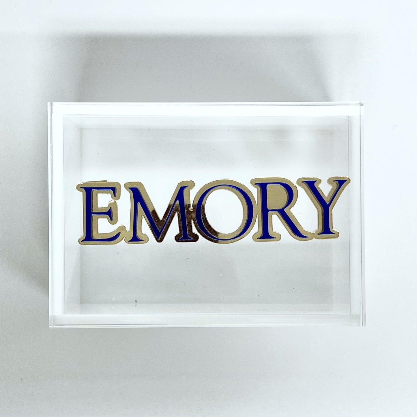 Framed artwork with 'EMORY' in blue