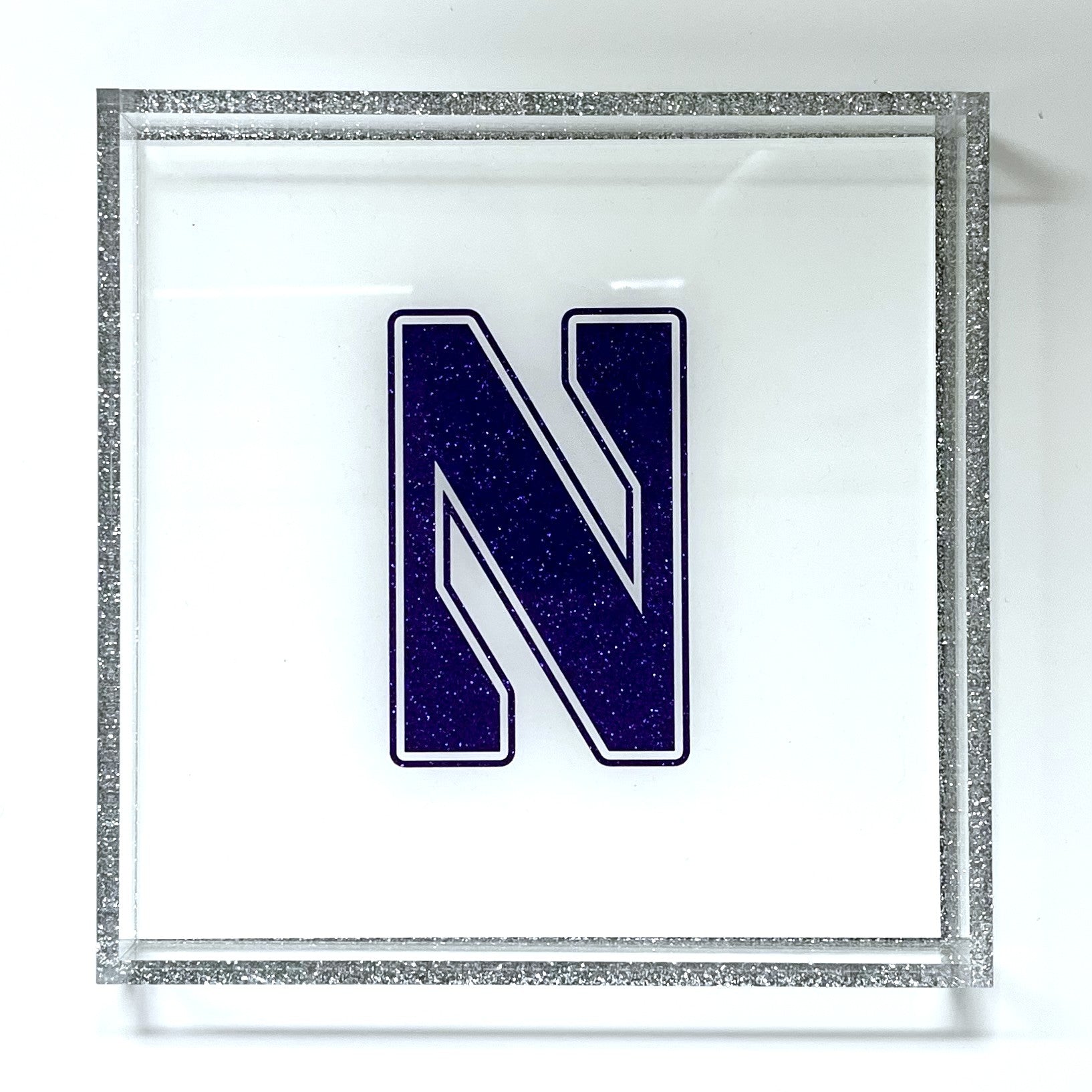 Decorative letter 'N' with a glittery silver