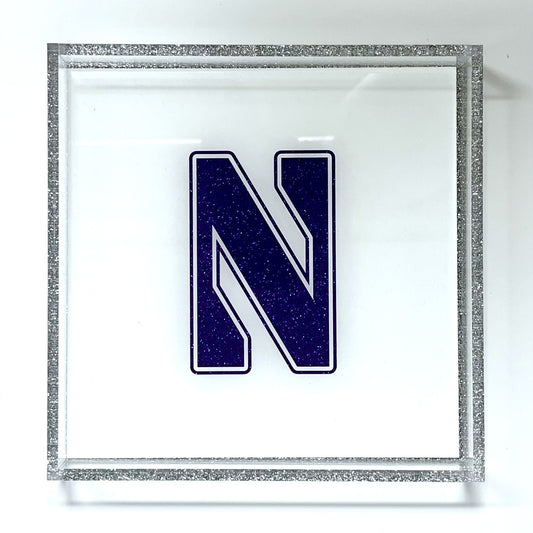 Decorative letter 'N' with a glittery silver
